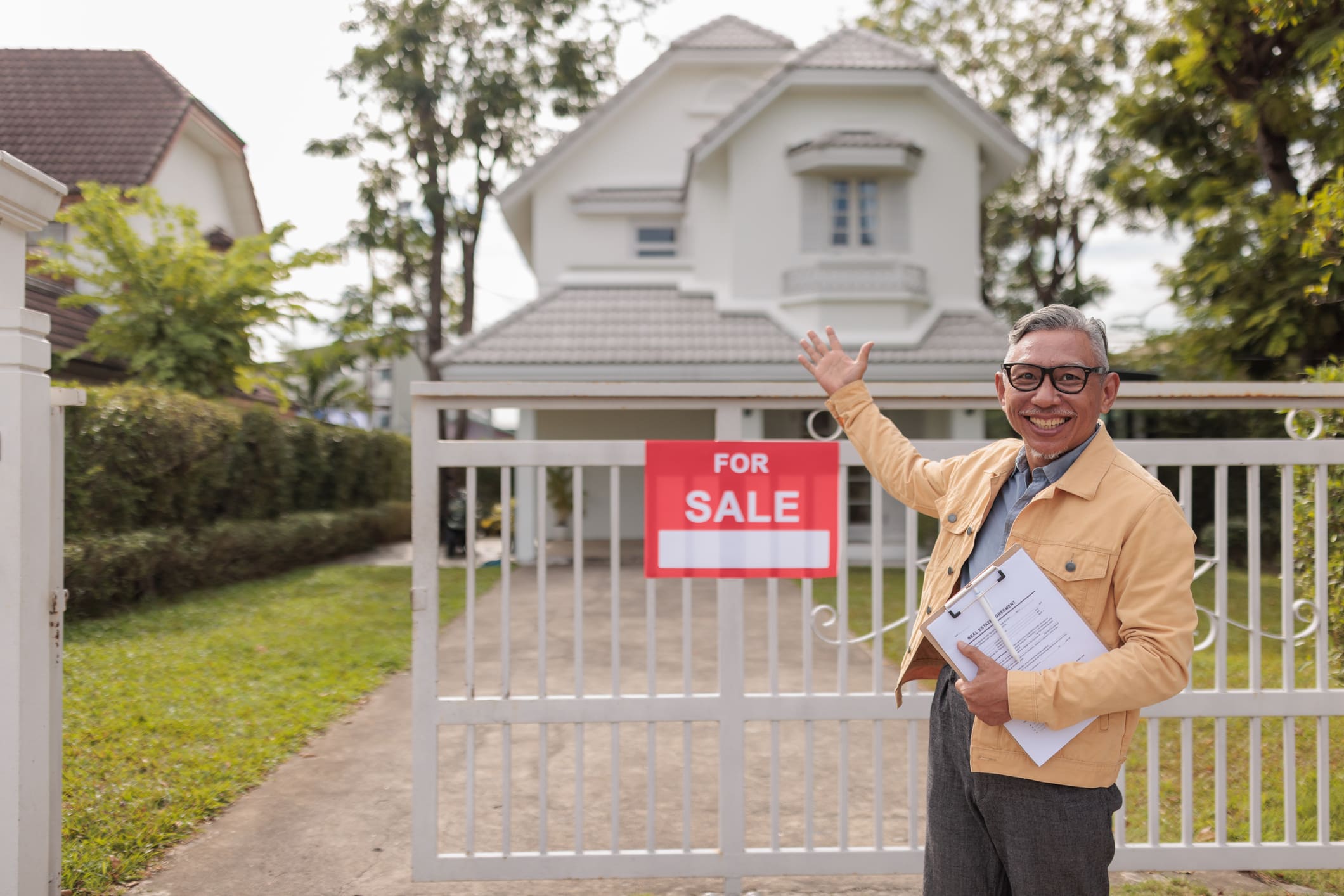 Smiling man presenting property for sale